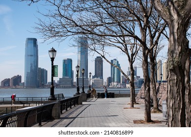 New York USA,  March 10th 2022, A tree lined view from the World Financial Centre across the Hudson River towards Jersey city on a crisp March day. 