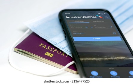 New York, USA, March 2022: Phone With The American Airlines Mobile App On The Screen Lying Over A Protective Mask And A Passport. Travel Safety And Restrictions During Coronavirus Pandemic