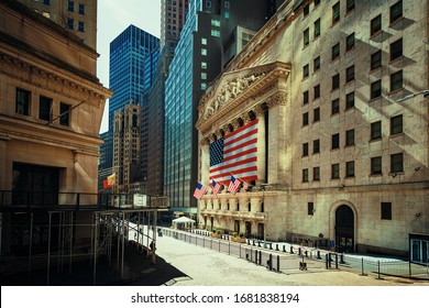 NEW YORK, USA - MARCH 21, 2020: Empty Wall Street with few pedestrians and traffic as the result of COVID-19 coronavirus pandemic outbreak in New York City.