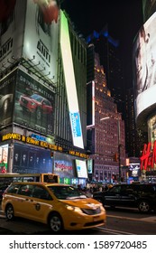 New York, USA – March 22, 2016: Vertical Night View Of Times Square Traffic And Neon Signs, Midtown Manhattan