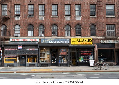 New York, New York USA - March 25 2021: Row of Old Stores and Restaurants along an Empty Street and Sidewalk in Greenwich Village of New York City