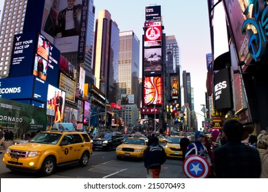 NEW YORK, USA - MARCH 26: Unknown people on Times Square. Times Square is a major commercial intersection and a neighborhood in Midtown Manhattan on March 26, 2014 in New York, USA - Shutterstock ID 215070493