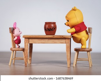 New York, USA - March 30, 2020: Winnie The Pooh And Piglet Going To Eat Honey On The Table.