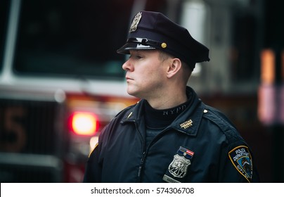 NEW YORK, USA - May 02, 2016: Police officer performing his duties on the streets of Manhattan. New York City Police Department (NYPD) is the largest municipal police force in the United States