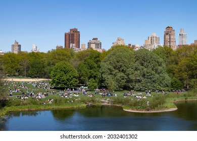 New York, New York USA - May 1 2021: The Great Lawn And Turtle Pond With Crowds Of People During Spring At Central Park In New York City