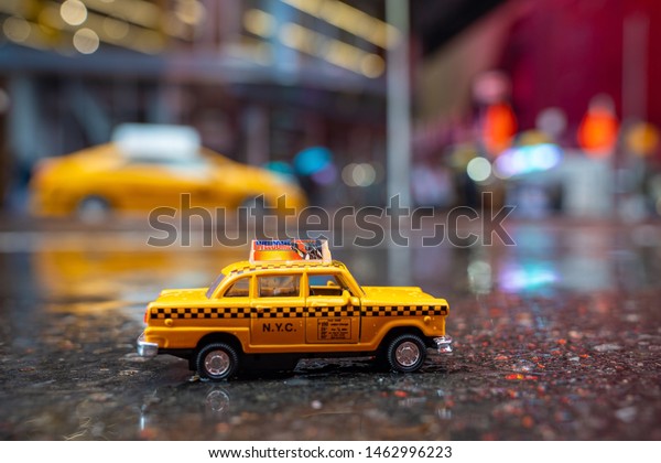 New York, USA. May 10, 2019. Vintage old Taxi toy in New\
York City most popular places. Classic Yellow Cab in Manhattan and\
Brooklyn. The symbol of New York. Driving a taxi through Manhattan.\
