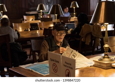 New York, USA - May 2019 - Old Man Reading Newspaper At The New York Public Library On Fifth Avenue In Manhattan.