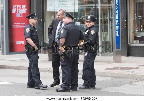 New York, USA - May 24, 2017:\
Police officers on the streets, after that a 16-year-old boy\
stabbed and slashed four of his classmates outside a Midtown\
school
