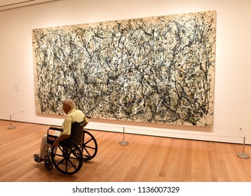 New York, USA - May 25, 2018: A Man In Wheelchair Looks At The Jackson Pollock Painting In Museum Of Modern Art In New York City.