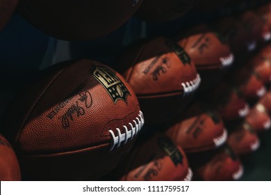 NEW YORK, USA - MAY 28, 2018: Rows of american football balls in NFL Experience in Times Square, New York, a first-of-its-kind live action attraction, combining interactive games and 4D theatre.