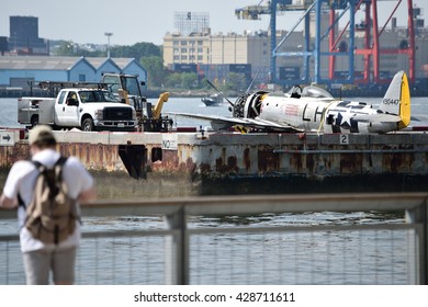 NEW YORK, USA - MAY 29, 2016: P-47 WW2 Plane Tail Number 490447 Crashed Into The Hudson River. The Plane Seen On The Pier 6 Heliport Temporarily. A Man Stops And Prepares To Take A Picture.