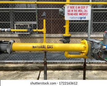 New York, New York / USA - May 3 2020: Section Of National Grid Gas Piping With Warning Sign Outside Of A Building In Queens, NYC