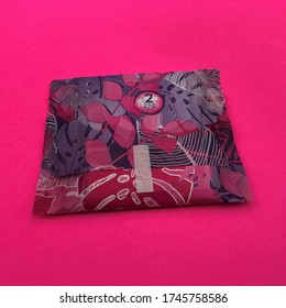 New York, New York / USA - May 30 2020: Closeup Of An Always Brand Maxi Pad (Radiant With FlexFoam) In A Wrapper Against Bright Pink Background