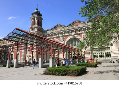 New York, USA -  May 30, 2015: Main Building which houses the Ellis Island National Museum of Immigration entrance with tourists outside.