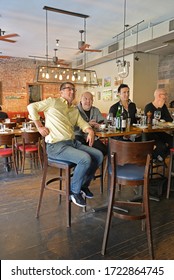 NEW YORK, USA - MAY 7, 2019: Men, Visitors Of Sports Cafe, Watching Sports Show On TV