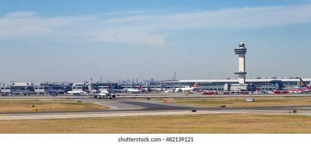 NEW YORK, USA - OCT 20, 2015: Air Traffic Control Tower and Terminal 4 with Air planes at the gates in JFK Airport in NY. 1963 the airport was rededicated John F. Kennedy International Airport.