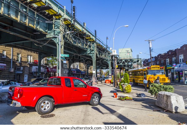 NEW YORK, USA - OCT 20, 2015: people at the\
crossing at Metro station New Lots Av Avenue in east New York build\
as elevated train in New York, USA. The red line connects east with\
north west New York.