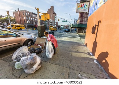 NEW YORK, USA - OCT 21, 2015: Woman Poses Garbage At The Street In Brooklyn, New York. Poverty Is A Main Social Issue In New York And Many People Life From Collecting Garbage.