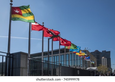 NEW YORK, USA - OCT 4, 2017:  UN Nations Building With Flags Of Participating Countries In Sun.