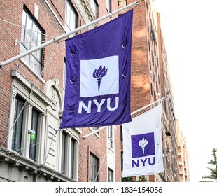 New York, New York, USA - October 14, 2020: NYU flags on a resicence hall in Manhattan.