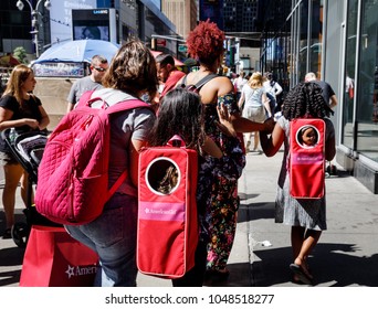 NEW YORK, USA - Sep 23, 2017: Manhattan street scene. New Yorkers and tourists in a hurry about their business, walking and relaxing on Times Square in NYC. Women with children and backpacks for dolls
