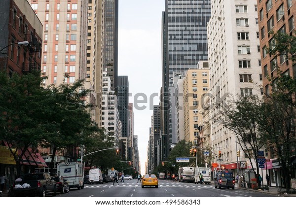New York, USA - September 23, 2015: \
Yellow taxi and people on the street of New\
York.