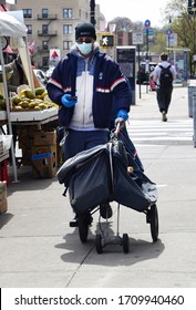 NEW YORK, NEW YORK-APRIL 2020: A Mailman Walks His Route In Upper Manhattan, As The US Postal Service Is On The Verge Of Bankruptcy. 