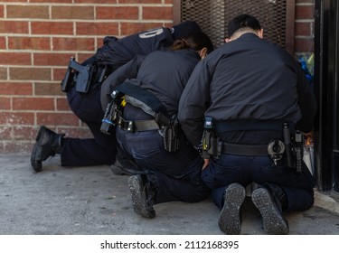 New YorkCity, NY USA January 24, 2022. Police officers light candles and lay flowers outside of the apartment building where officer Wilbert Mora lived.  - Shutterstock ID 2112168395