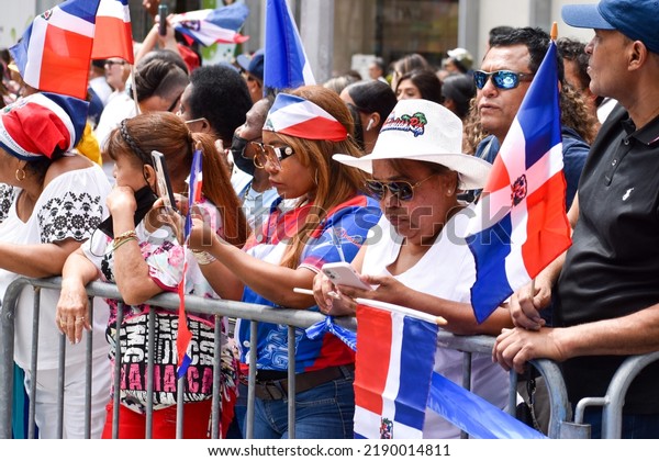 New Yorkers of all ages are seen wearing Dominican\
flag during the Dominican Day Parade on Sixth Avenue in New York\
City.
