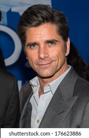 NEW YORK-JAN 29: Actor John Stamos (R) visits the Dannon Oikos Tent on Park Avenue on January 29, 2014 in New York City.