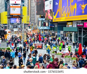 New York/USA 15. April 2016: Numerous people in Times Square, crowds of tourists visit NYC and especially Manhattan USA daily. A big apple is a guarantee of a great experience and performance show. - Shutterstock ID 1576515691