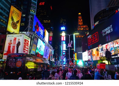 New York/USA - 25 September 2018: Tourists in Times Square at night, featured with Broadway Theaters and animated LED signs, is a symbol of New York City and the USA.                      