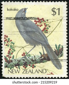 NEW ZEALAND - CIRCA 1985: Postage stamp printed in New Zealand with image of an endangered Kokako bird perched on a tree branch.circa 1993.