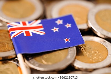 New Zealand Flag On Coins Background : Business And Finance Concept.