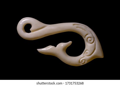 New Zealand Maori Handmade Carved Ox Bone Necklace Isolated On A Black Background.