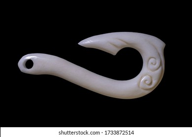 New Zealand Maori Handmade Carved Ox Bone Necklace Isolated On A Black Background.