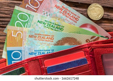 New Zealand Money In The Wallet On The Wooden Table Top.