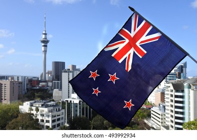 New Zealand National Flag Waving Against Auckland City Skyline, New Zealand. No People. Copy Space 