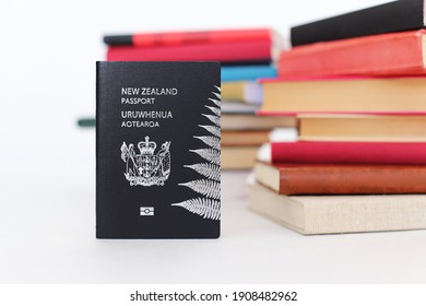 New Zealand passport on the table with books
