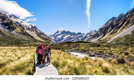 NEW ZEALAND, SOUTH ISLAND, MOUNT COOK - FEBRUARY 2016: A Group Of Young Traveler Explores Hooker Valley Track. Working Holiday Visa Is Popular Among Young People And Traveler To Explore New Zealand.