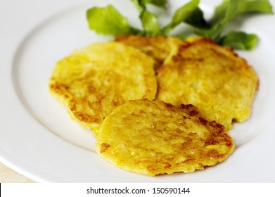 New Zealand Sweet Corn Fritters On White Plate And Rocket Leaf.