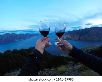 New Zealand, Wanaka Lake Travel Vacation. Happy Couple/friends Happy On The Mountain Top Hands Up With Wine Glasses, Enjoying Mountain, Lake Landscape Outdoor View. Freedom, Happiness Lifestyle