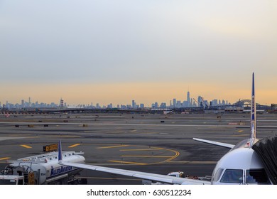 At Newark Airport, Newark, NJ - December 31, 2016: United Airlines Airplane In The Newark Airport With New York Silhoutte