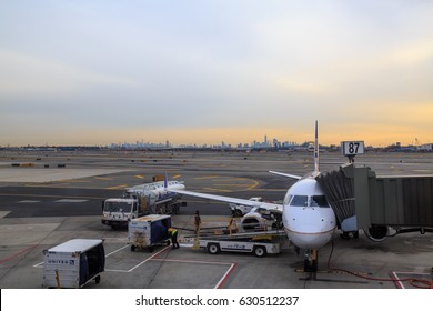 At Newark Airport, Newark, NJ - December 31, 2016: United Airlines Airplane In The Newark Airport With New York Silhoutte