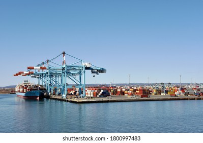 Newark, NJ / USA - View of the container terminal with berthed ship, gantry cranes are loading and discharging cargo from the vessel.	 - Shutterstock ID 1800997483
