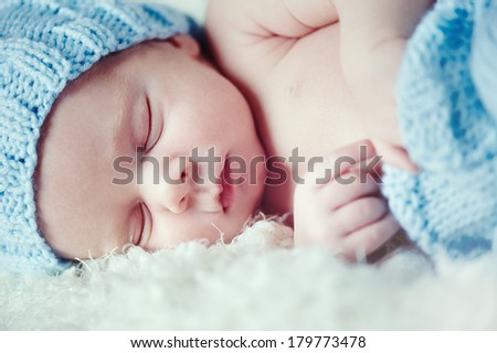 Similar – Newborn baby girl sleeping lying on blanket on bed