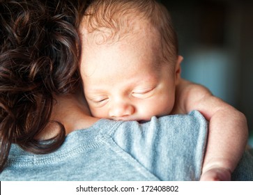 Newborn Baby In The Arms Of His Mother