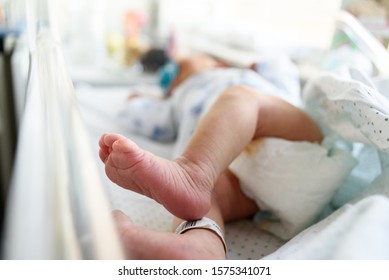newborn baby with barcode identification on the ankle 
