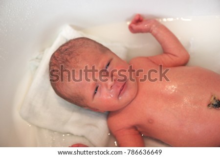 Similar – Newborn in the bathtub with her mother washing her hair