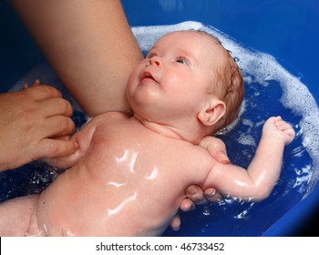 Newborn Baby Bath In Blue Bathtub By Mother